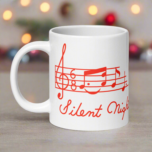 This ceramic glossy mug features a midcentury retro print that says Silent Night and shows the first few notes of the beautiful song. The entire artwork is red.