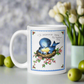 This ceramic white glossy coffee mug features a Mid Century Retro Print of a mama bluebird with her babies in a nest. There are pink flowers and a blue frame with the words: To Mommie Dear On Mother&#39;s Day. A beautiful vintage print.