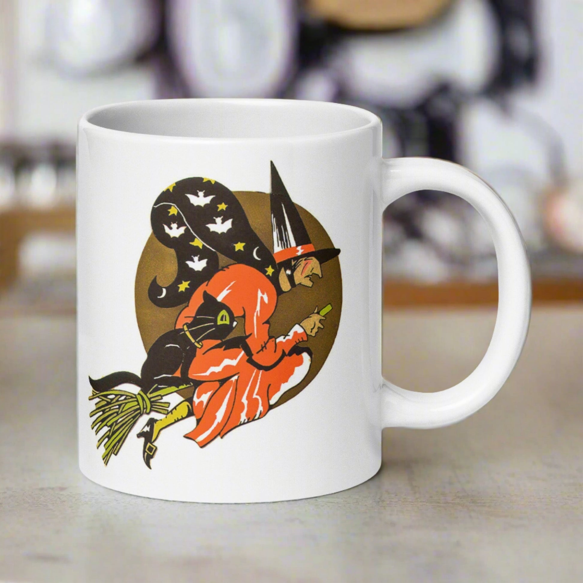 This ceramic glossy coffee mug features a retro vintage Halloween print of a witch flying on her broom with her black cat and a gold moon in the background.