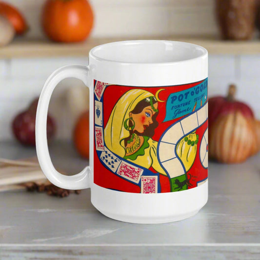 This ceramic glossy coffee mug features a vintage Halloween illustration of a Pot O'Gold Fortune Telling Game. It features a celestial fortune teller dressed in yellow with cards and a board game path.