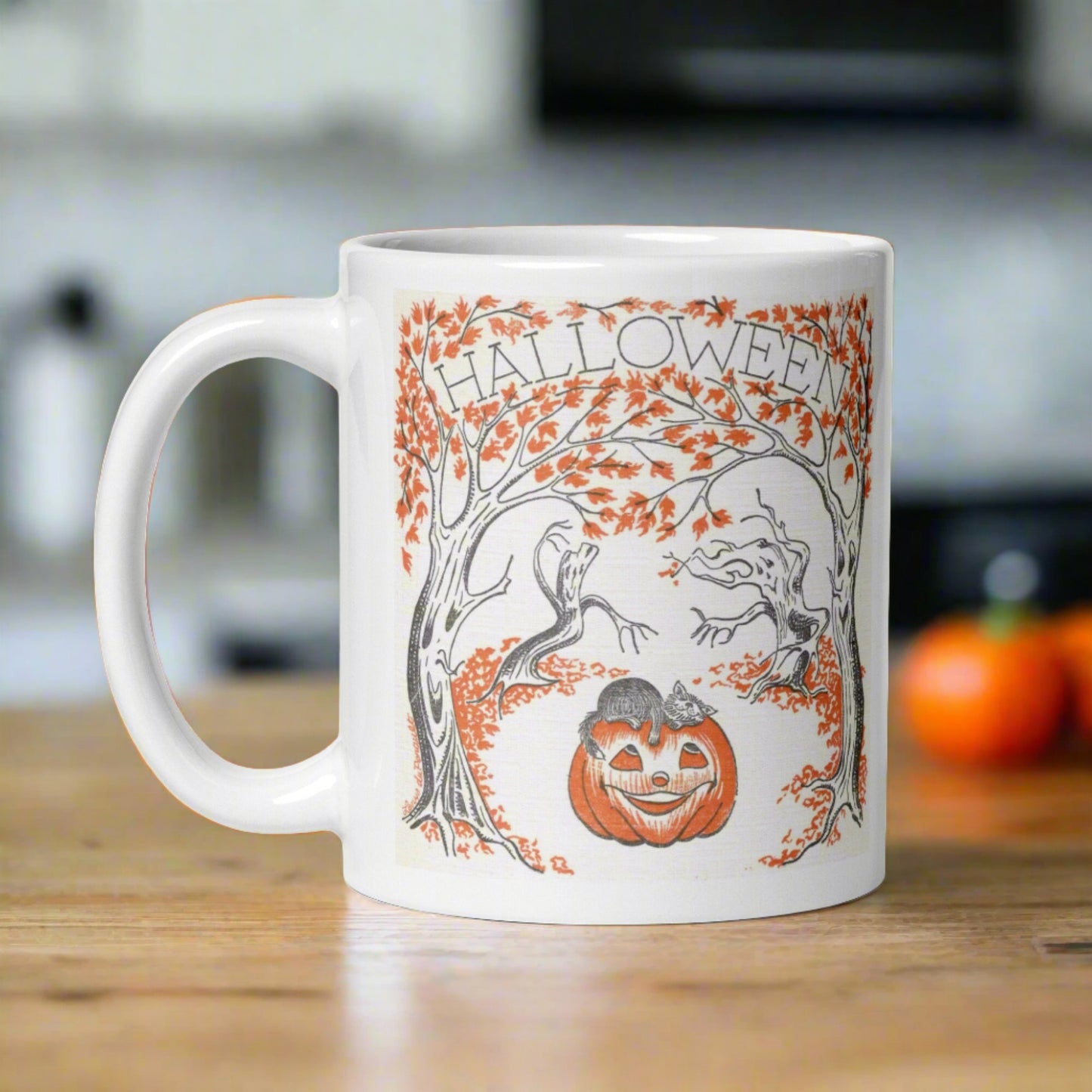 This glossy ceramic coffee mug features a retro vintage Halloween illustration that says Halloween with trees with spooky cute faces and orange leaves, with a jack o lantern in the middle and a black cat sleeping on the pumpkin.