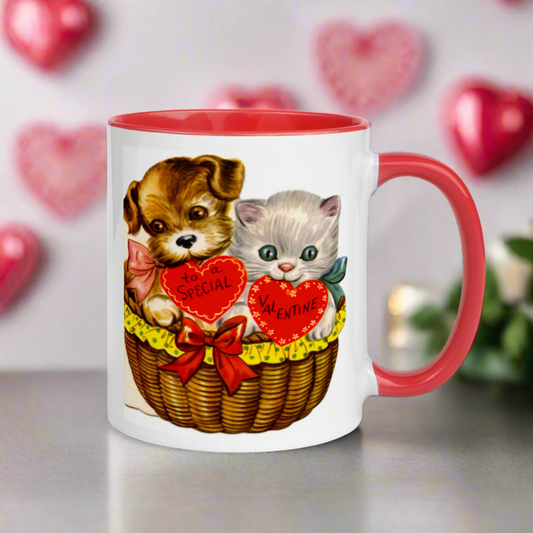 This ceramic glossy red lined mug features a midcentury retro Valentine's Day illustration of a puppy and kitten in a basket. The puppy is holding a heart that says To a Special and the Kitten's heart says Valentine.