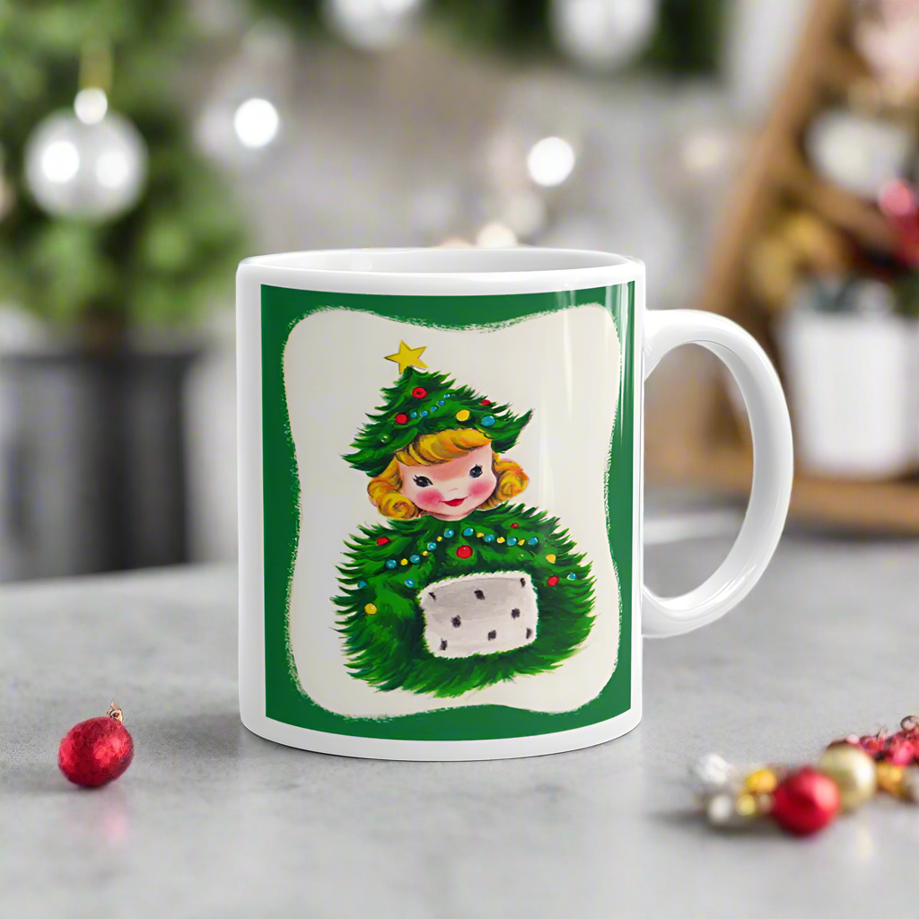 This ceramic glossy coffee mug features a blond girl wearing a christmas tree hat and coat. The hat is adorned with a yellow star on top. She is also wearing a white and green muff.