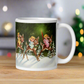 This ceramic glossy mug features three young angels riding reindeer in the snow.