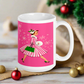 This ceramic glossy mug features a vintage Christmas illustration of a retro Midcentury housewife dressed in a pink and white striped dress with a green purse and heels. The background is pink and there are snowflakes. 