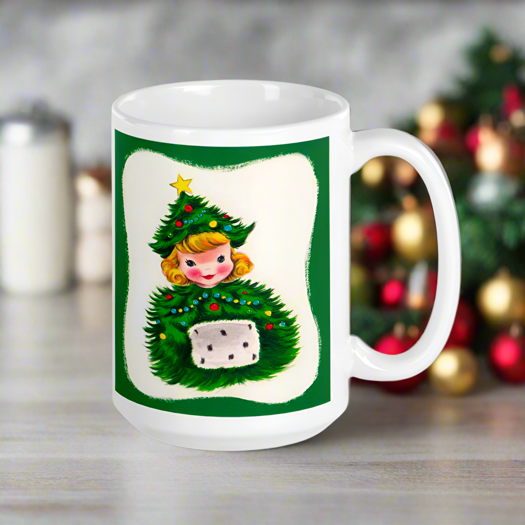 This ceramic glossy coffee mug features a blond girl wearing a christmas tree hat and coat. The hat is adorned with a yellow star on top. She is also wearing a white and green muff.