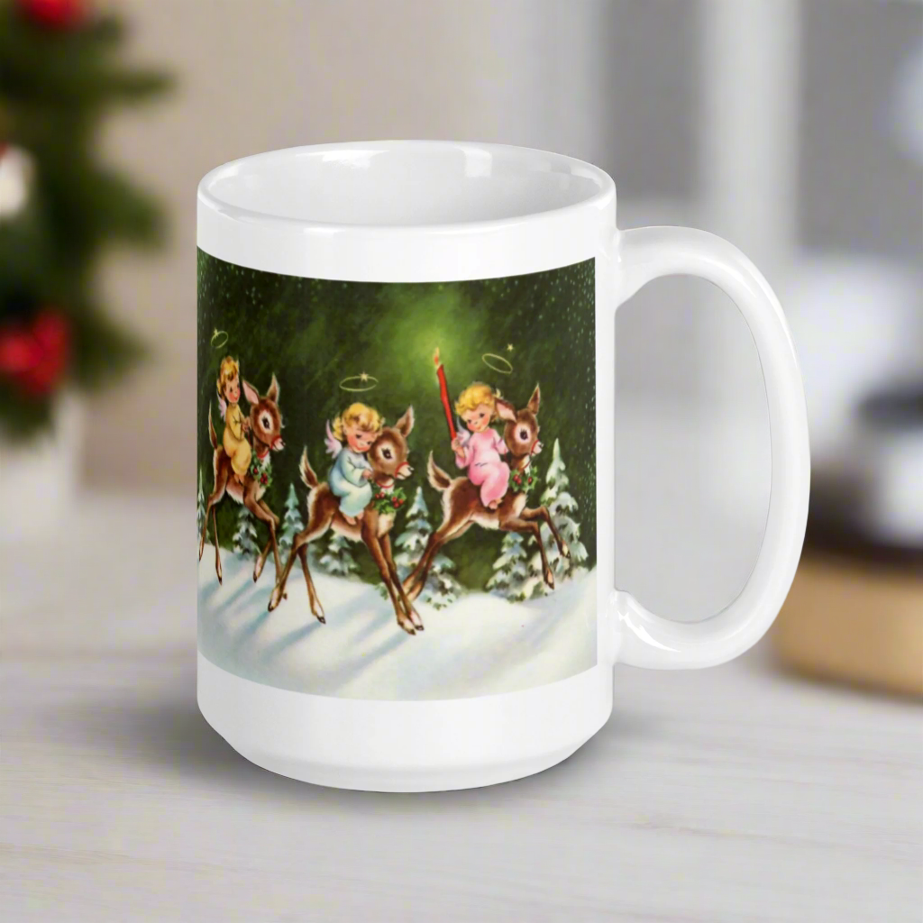 This ceramic glossy mug features three young angels riding reindeer in the snow.