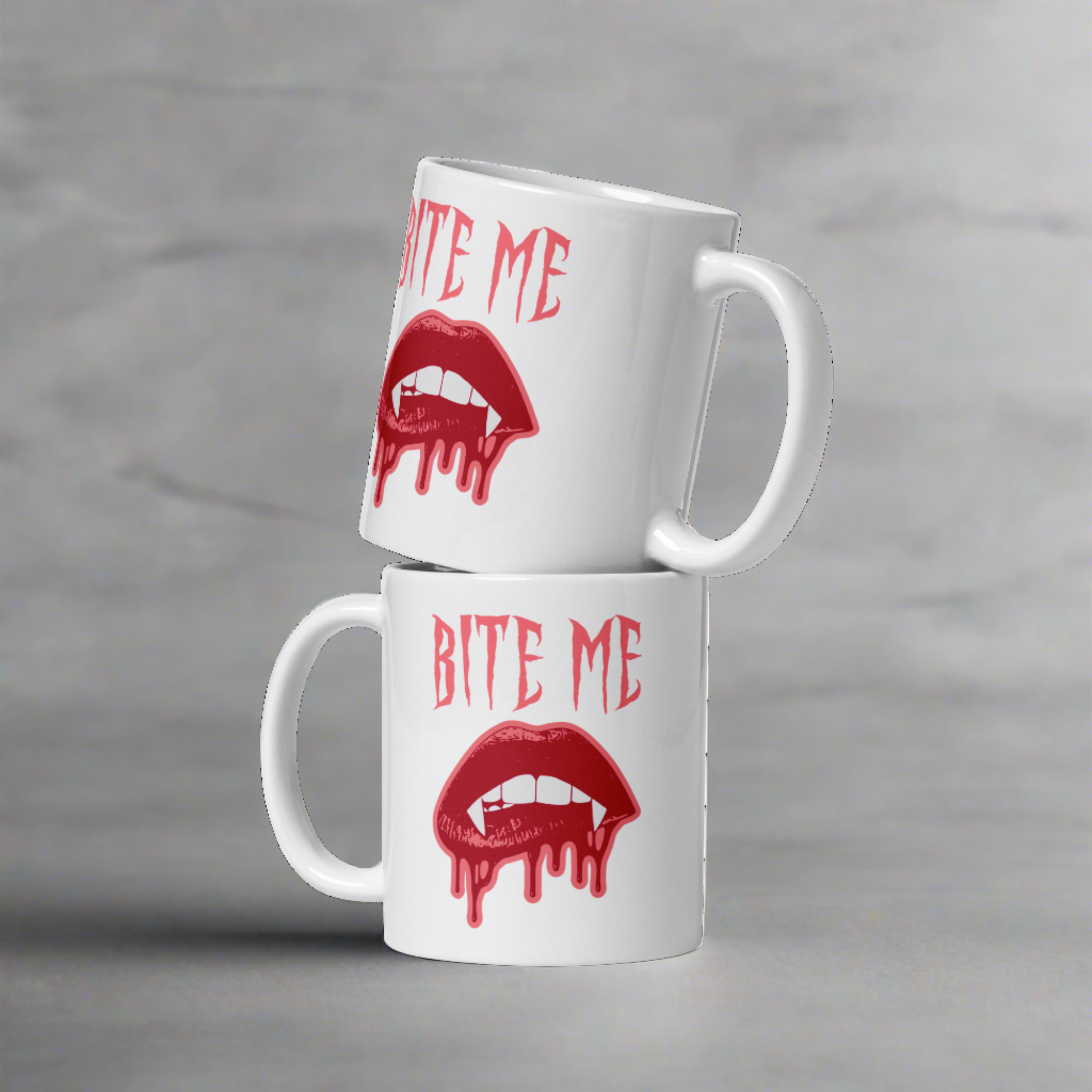 This ceramic coffee mug features the words Bite Me in gothic style with an art design of vampire lips and fangs. 