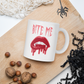 This ceramic coffee mug features the words Bite Me in gothic style with an art design of vampire lips and fangs. 