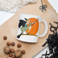 This ceramic coffee mug features a vintage deco illustration of a cute flapper witch flying on a broom with an orange full moon behind her. 