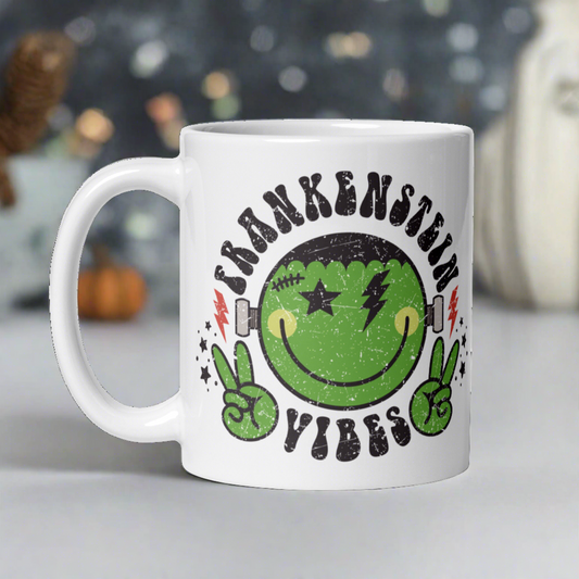 This ceramic glossy mug features a distressed style artwork of an adorable Frankenstein Monster making the peace sign with his hands. Lettering says Frankenstein Vibes around his head with little stars.