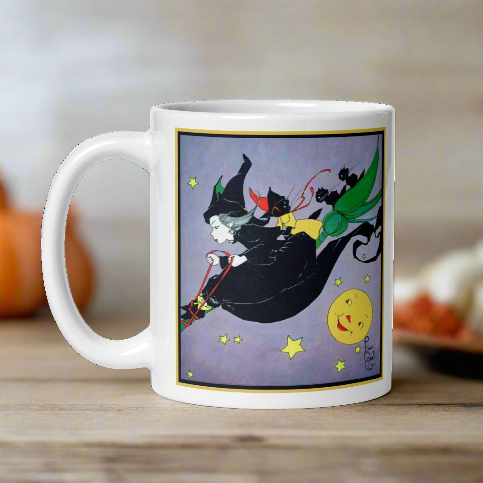 This ceramic glossy mug features a vintage Halloween illustration by Fern Bisel Peat. It features a witch dressed in all black soaring through the air on her broom with black cats. There is a smiling full yellow moon.