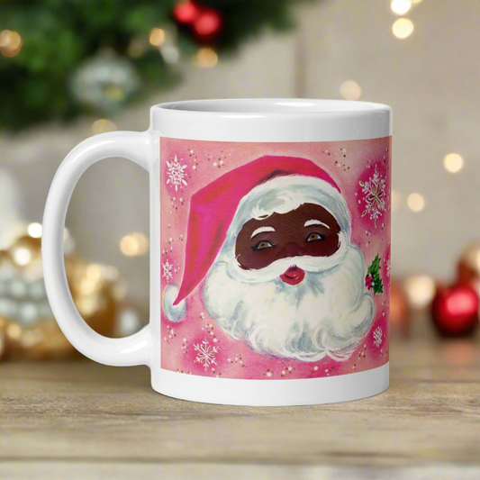 This glossy ceramic coffee mug features a retro Christmas illustration of a diverse Santa with mistletoe. There is a pink background with snowflakes.