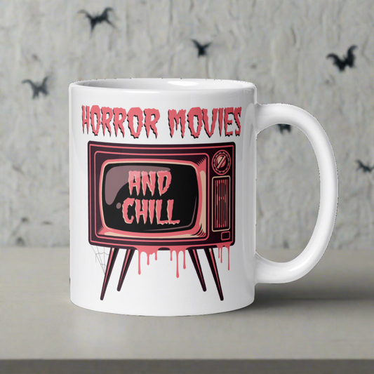 This ceramic glossy coffee mug features a retro style design that says Horror Movies And Chill. The And Chill appears on the retro television screen. The TV is dripping with pink blood.