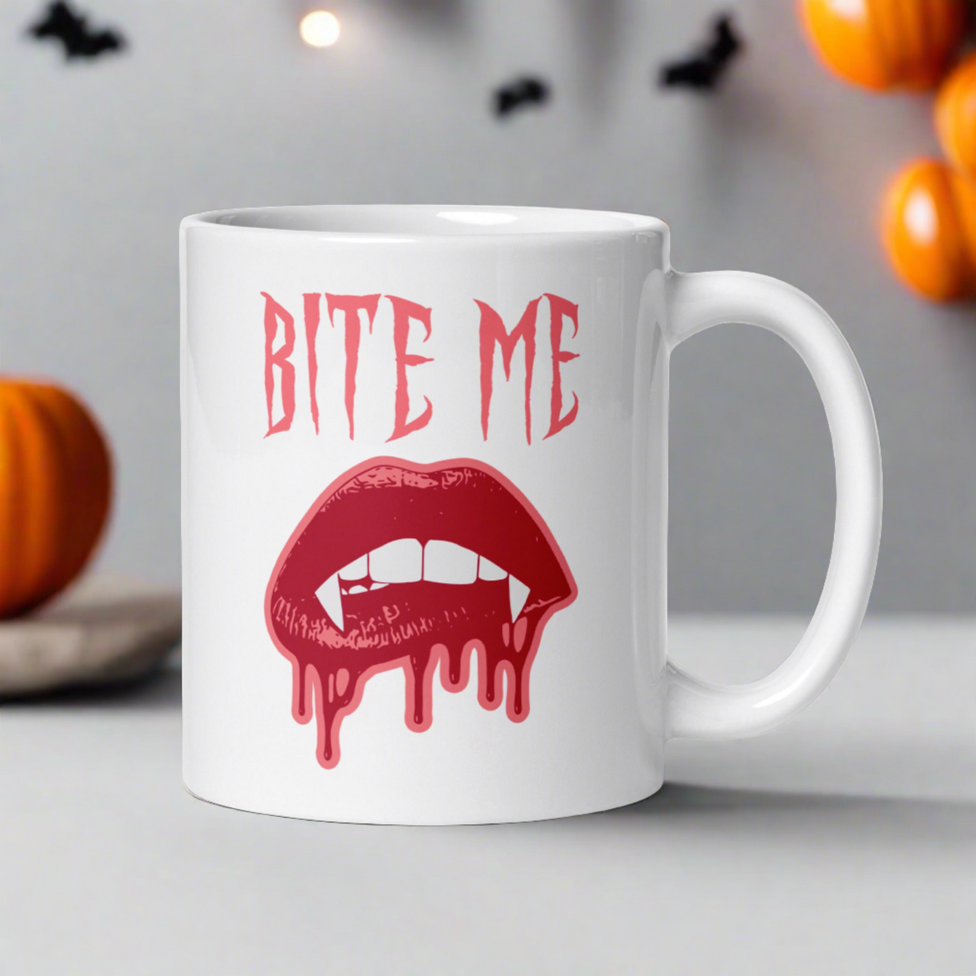 This ceramic coffee mug features the words Bite Me in gothic style with an art design of vampire lips and fangs. 