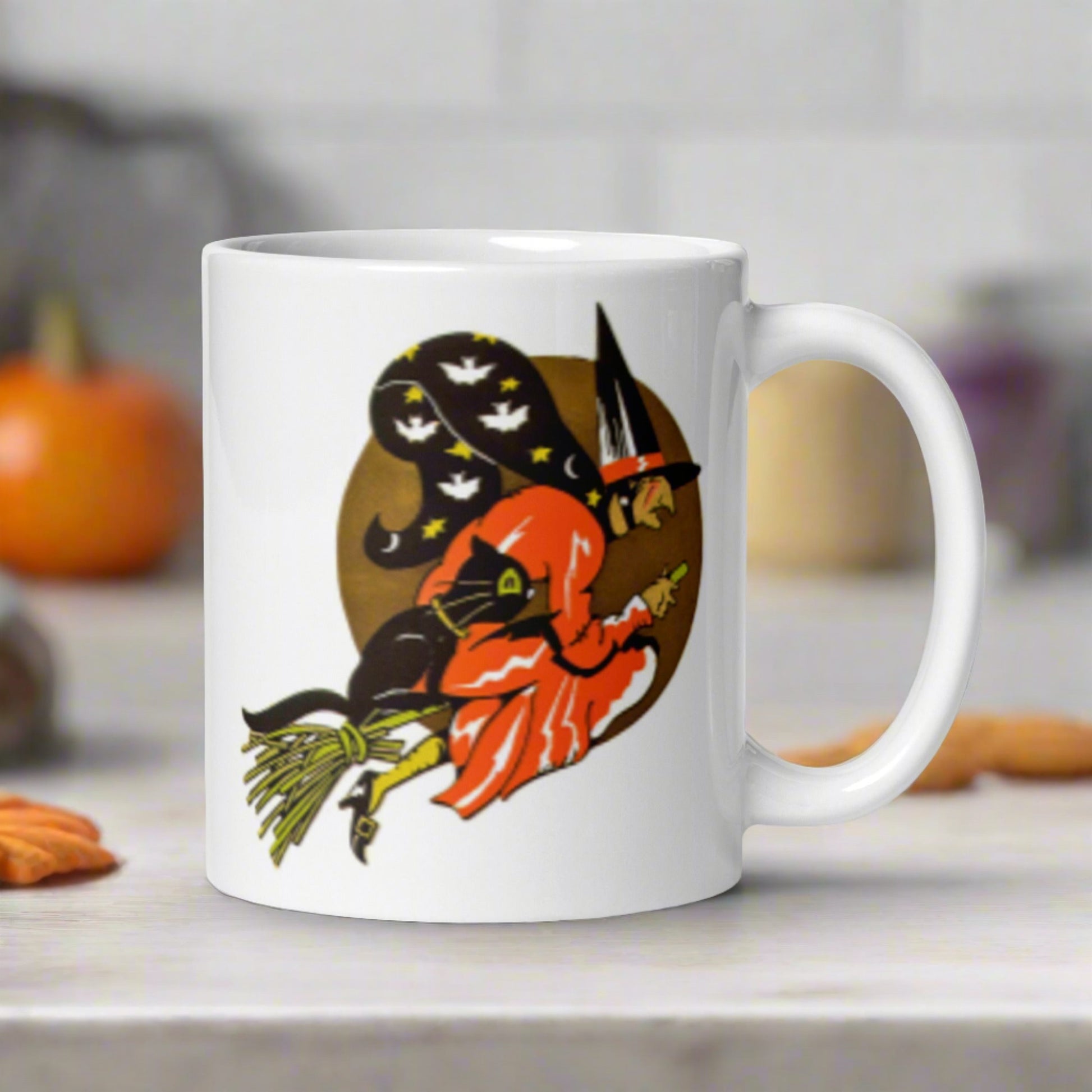 This ceramic glossy coffee mug features a retro vintage Halloween print of a witch flying on her broom with her black cat and a gold moon in the background.