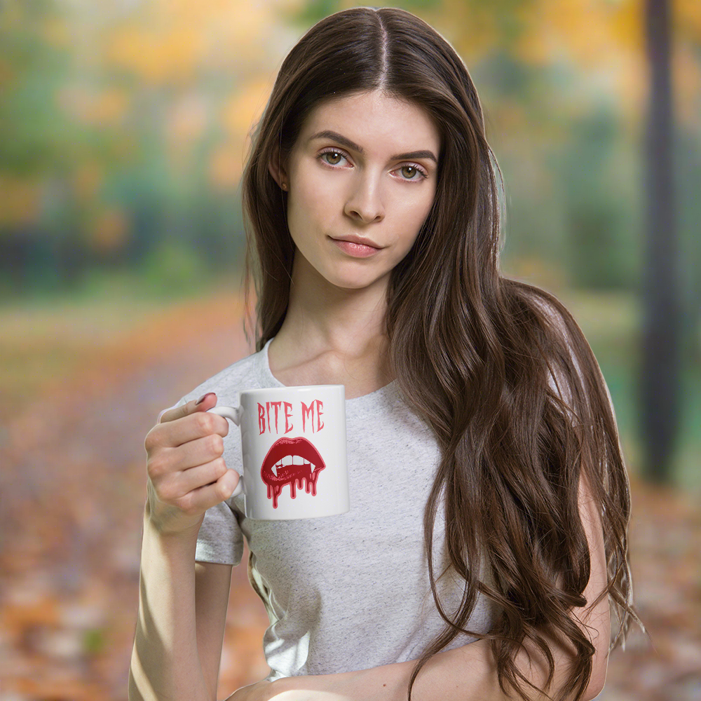 This ceramic coffee mug features the words Bite Me in gothic style with an art design of vampire lips and fangs. 