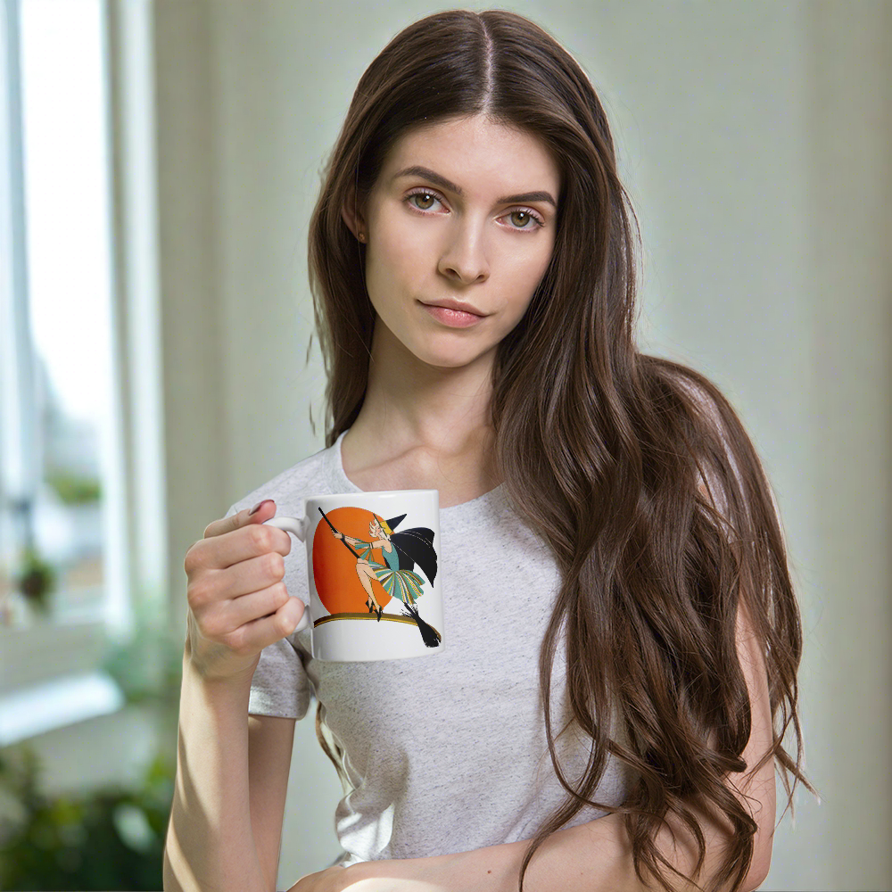 This ceramic coffee mug features a vintage deco illustration of a cute flapper witch flying on a broom with an orange full moon behind her. 