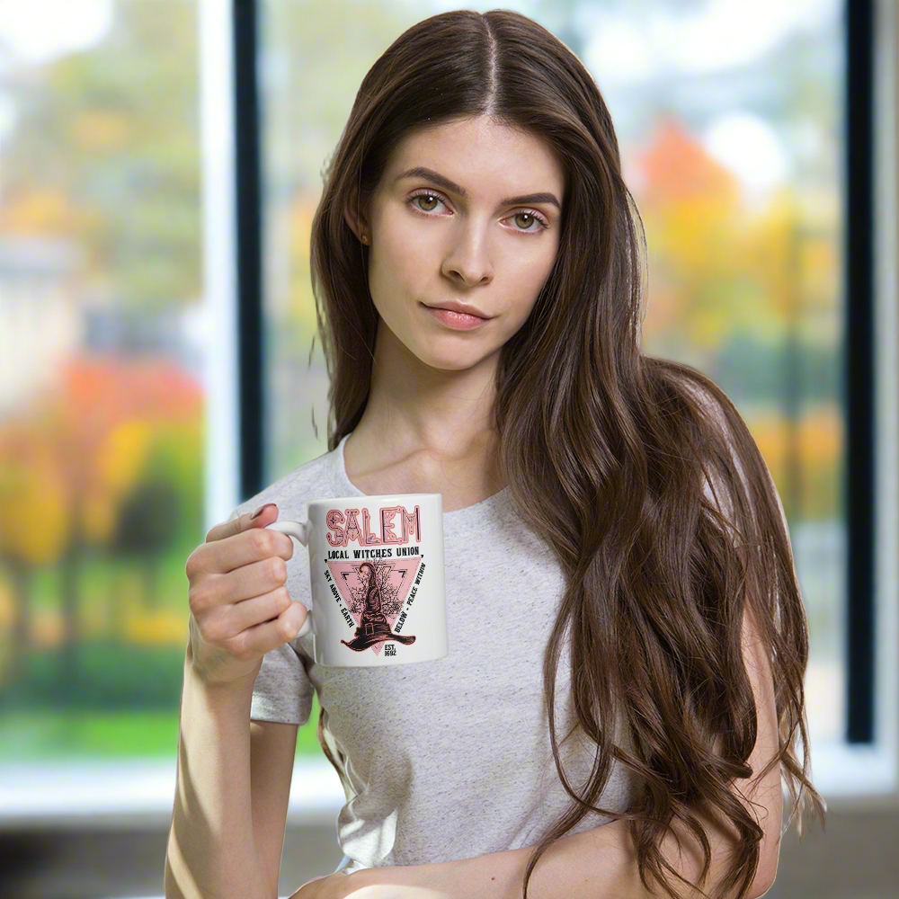 This ceramic glossy mug says Salem Local Witches Union and features a pointy pink and black witch's hat. It says Sky Above Earth Below Peace Within Est 1692.