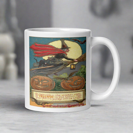 This glossy ceramic mug features a retro vintage Halloween print of a Victorian witch riding a broom with her black cat. The yellow moon is behind her, bats are flying, there are jack o lanterns and there is a Halloween poem.