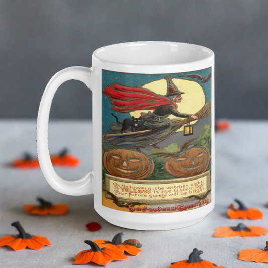 This glossy ceramic mug features a retro vintage Halloween print of a Victorian witch riding a broom with her black cat. The yellow moon is behind her, bats are flying, there are jack o lanterns and there is a Halloween poem.