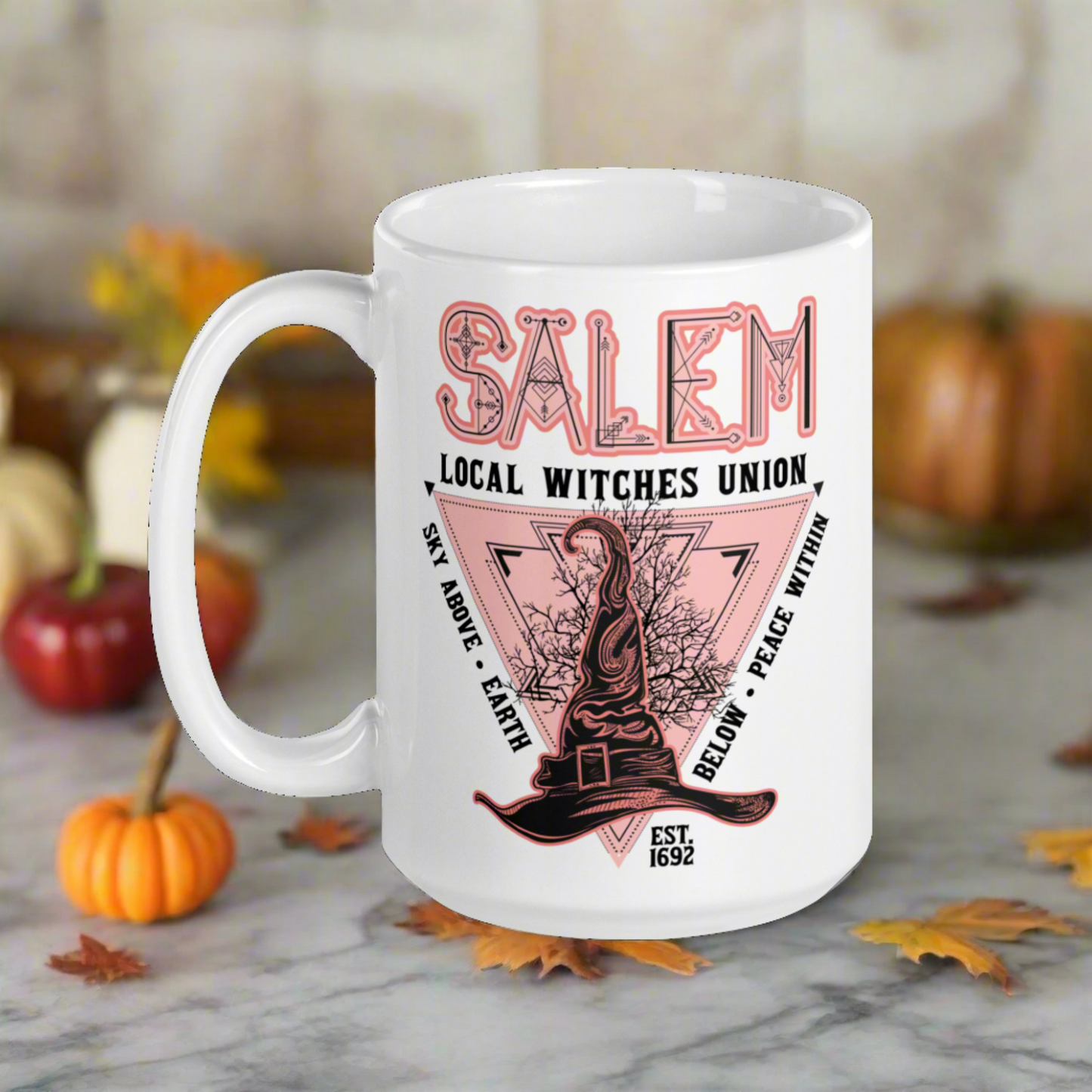 This ceramic glossy mug says Salem Local Witches Union and features a pointy pink and black witch's hat. It says Sky Above Earth Below Peace Within Est 1692.