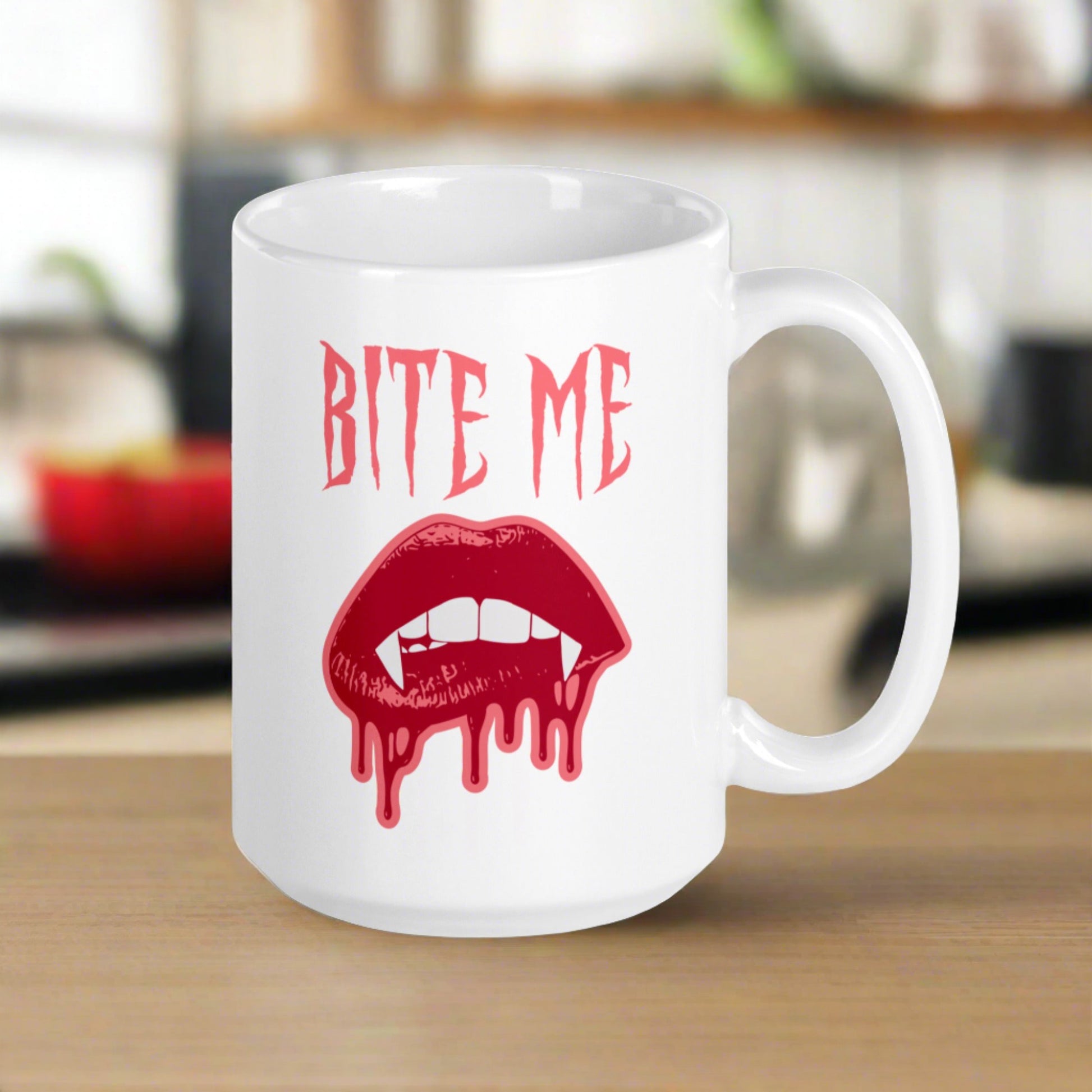 This ceramic coffee mug features the words Bite Me in gothic style with an art design of vampire lips and fangs. 