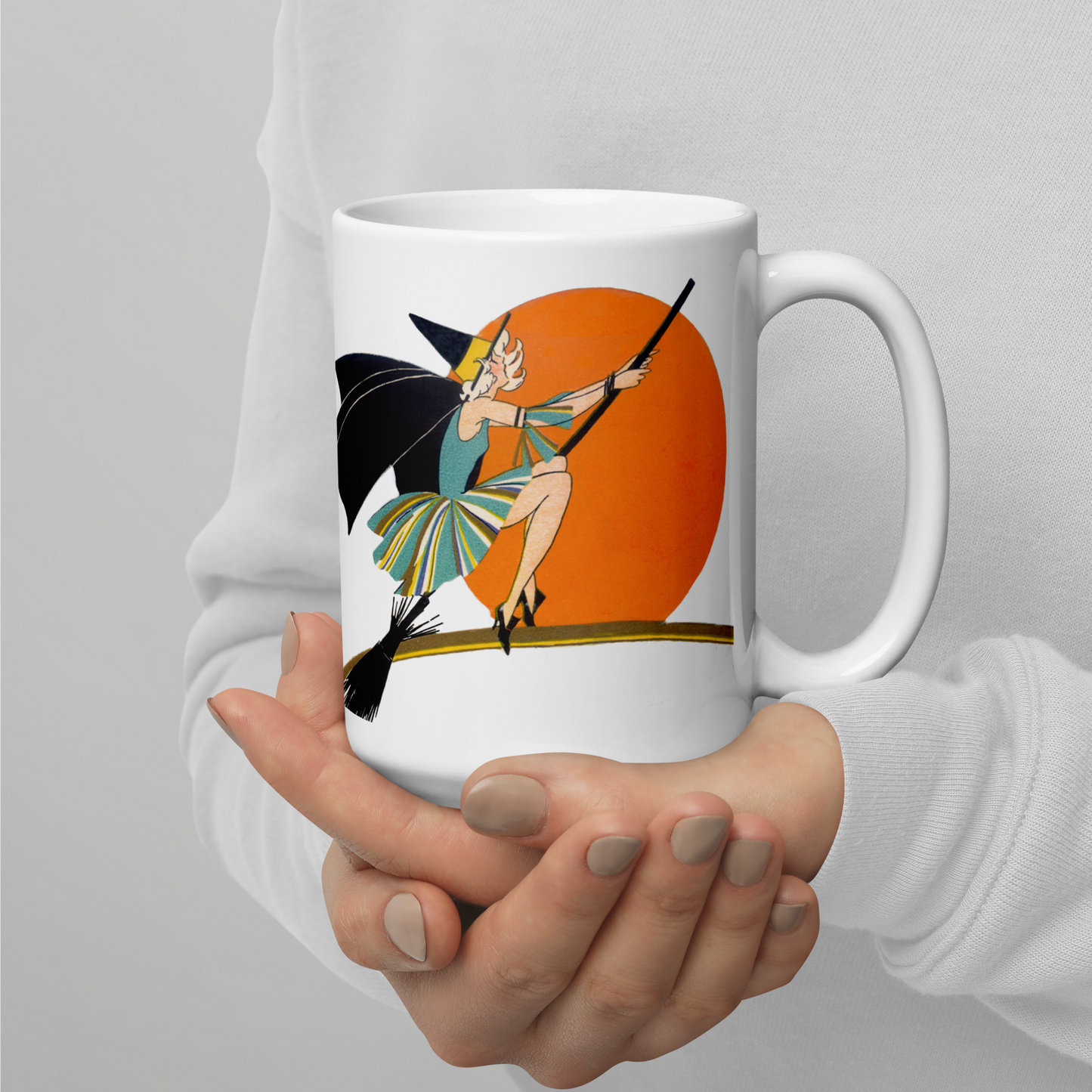 This ceramic coffee mug features a vintage deco illustration of a cute flapper witch flying on a broom with an orange full moon behind her. 