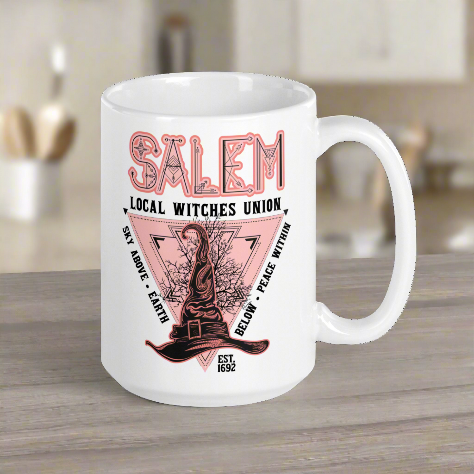 This ceramic glossy mug says Salem Local Witches Union and features a pointy pink and black witch's hat. It says Sky Above Earth Below Peace Within Est 1692.