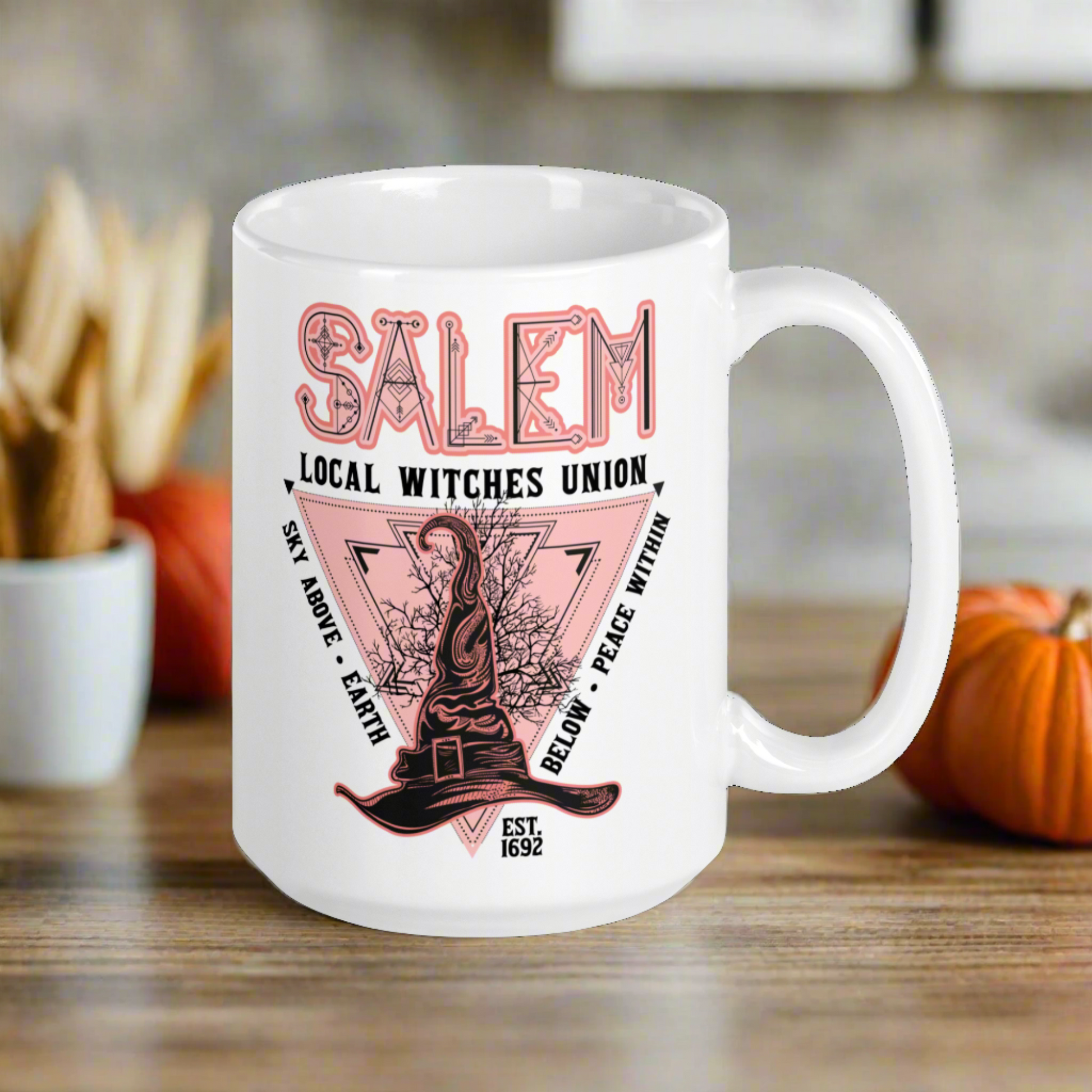 This ceramic glossy mug says Salem Local Witches Union and features a pointy pink and black witch's hat. It says Sky Above Earth Below Peace Within Est 1692.