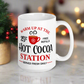 This ceramic glossy coffee mug says Warm Up At The Hot Cocoa Station Served Fresh Daily.It features a cute little red cup with a snowflake on it.