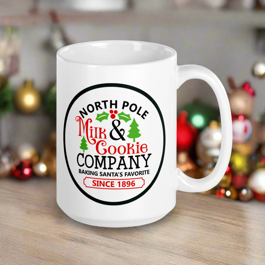 This ceramic glossy coffee mug says North Pole Milk and Cookie Company Baking Santa's Favorite Since 1896. It features little green trees and holly leaves and berries.