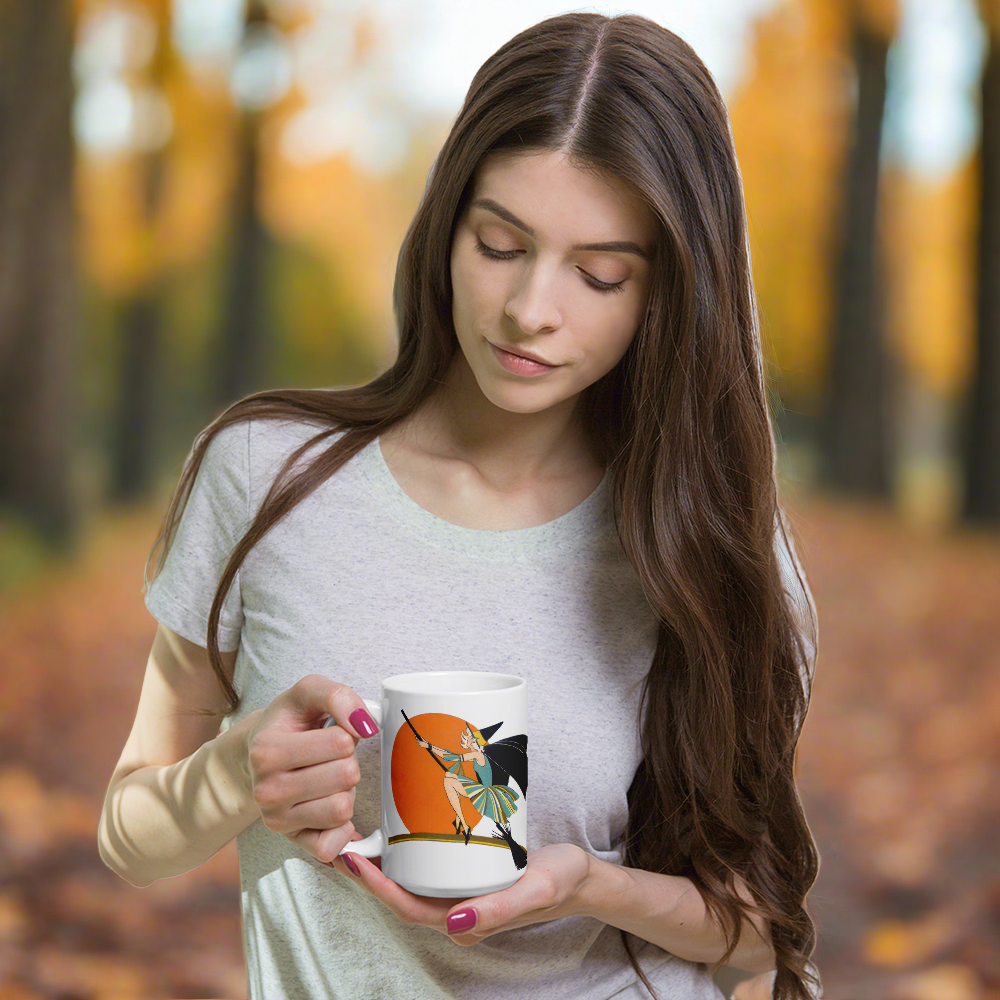 This ceramic coffee mug features a vintage deco illustration of a cute flapper witch flying on a broom with an orange full moon behind her. 