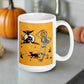 This ceramic glossy coffee mug features a vintage Halloween illustration of a skeleton with a jack o lantern for a head, a black cat, a black owl, a spooky house and a full moon. 