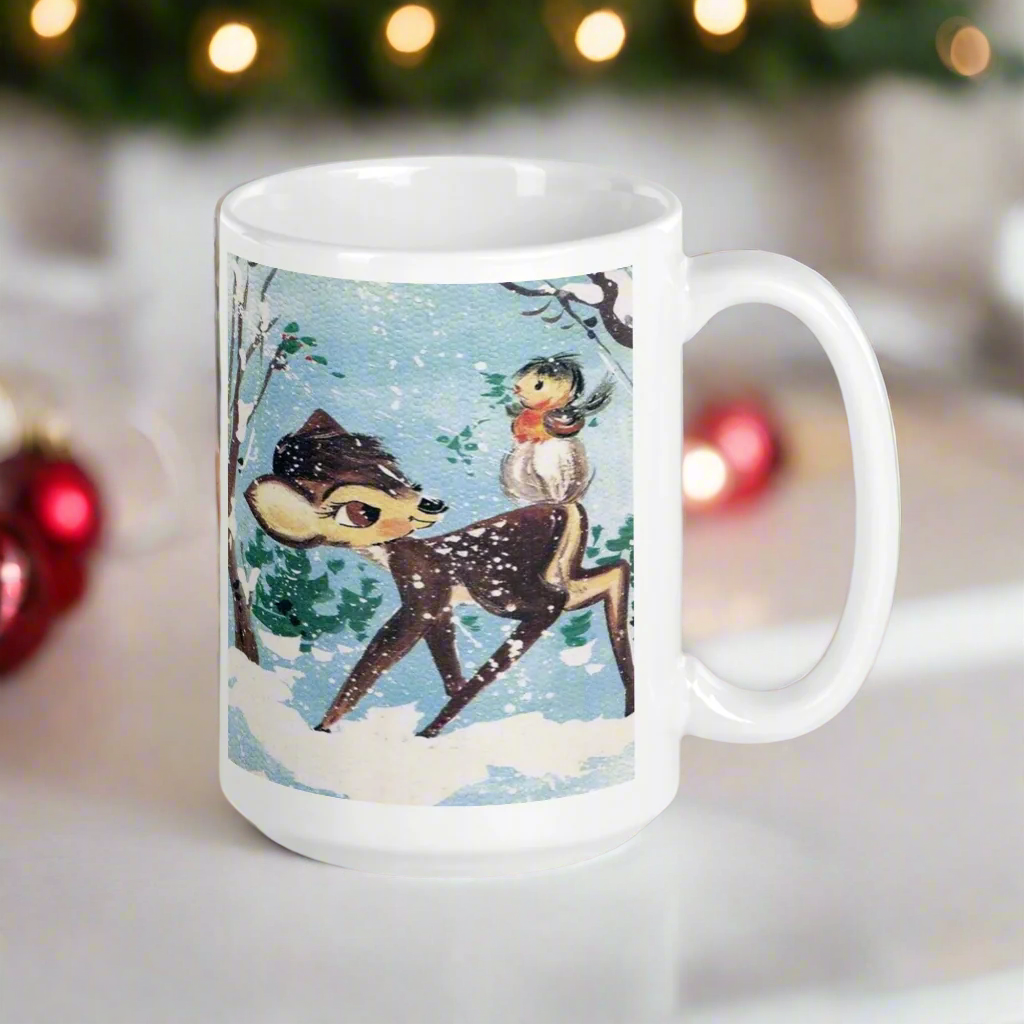 This glossy ceramic coffee cup features a retro woodland style Christmas winter illustration of a baby deer in the snow with a cute red and brown bird perched on her tail.