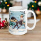 This glossy ceramic coffee cup features a retro woodland style Christmas winter illustration of a baby deer in the snow with a cute red and brown bird perched on her tail.