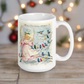 This ceramic glossy coffee mug features a retro Midcentury Christmas illustration of an angel dressed in pink directing blue, yellow and pink songbirds. At the top it says Merry Christmas HONEY