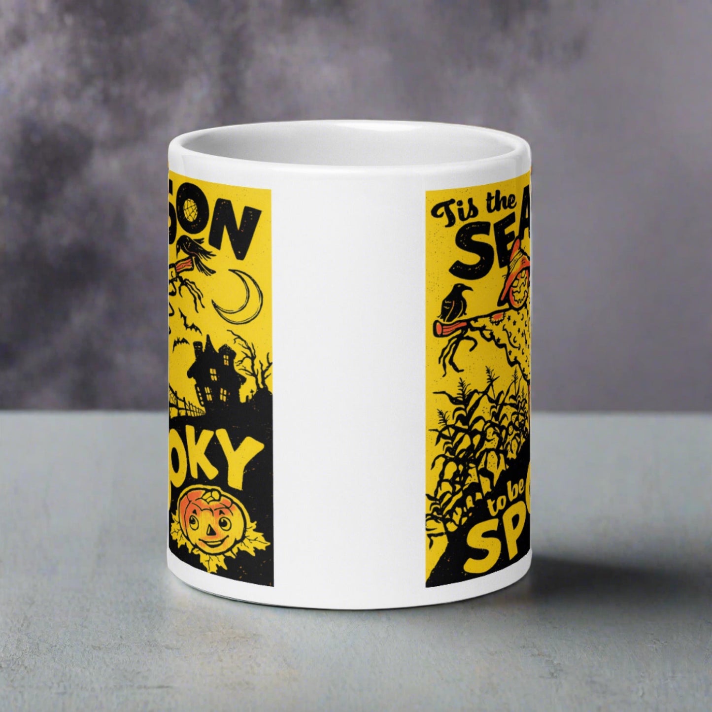 This ceramic glossy coffee mug features a retro vintage print that says Tis the Season to be Spooky. It is yellow and black and features a scarecrow, a cute jack o lantern and a spooky house in the background.