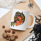 This ceramic glossy coffee mug features a retro vintage Halloween print of a witch flying on her broom with her black cat and a gold moon in the background.