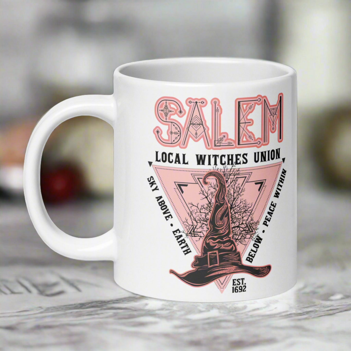 This ceramic glossy mug says Salem Local Witches Union and features a pointy pink and black witch's hat. It says Sky Above Earth Below Peace Within Est 1692.This ceramic glossy mug says Salem Local Witches Union and features a pointy pink and black witch's hat. It says Sky Above Earth Below Peace Within Est 1692.