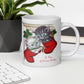 This white ceramic glossy coffee mug features two adorable kittens in red stockings at a Christmas mantle. The print is retro kitsch and says A Pair of Warm Wishes.